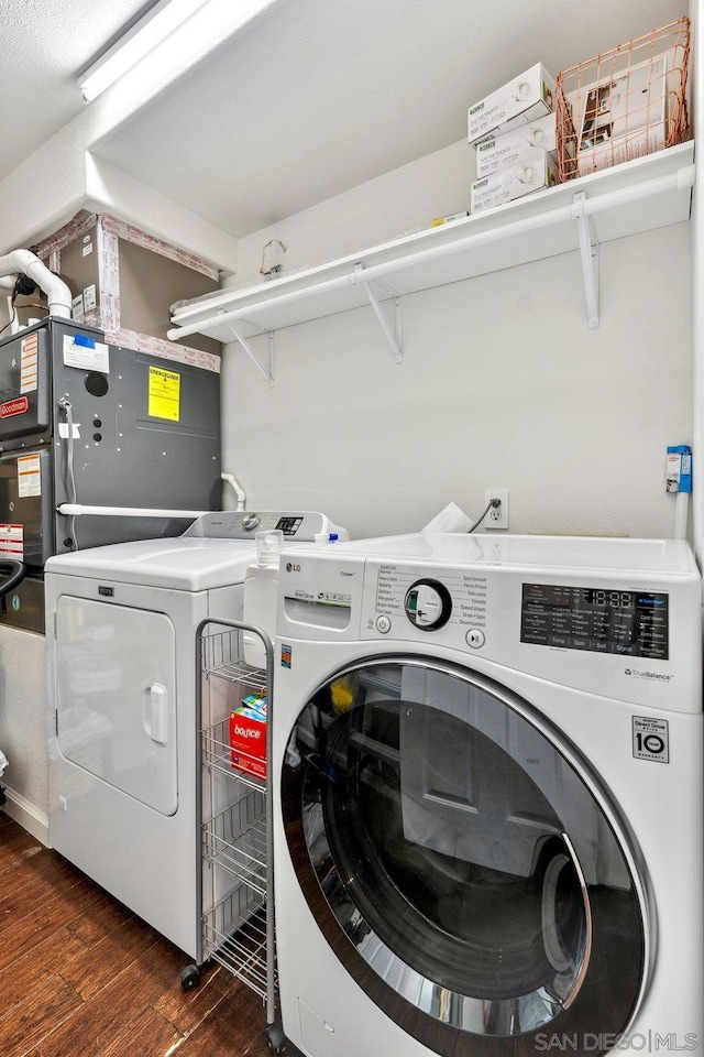 laundry area featuring dark wood-type flooring and washing machine and dryer