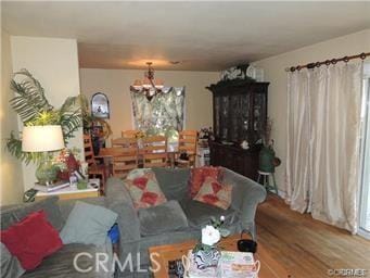 living room with a chandelier, hardwood / wood-style floors, and a wealth of natural light