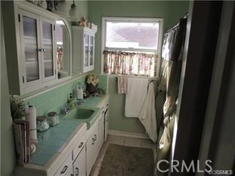 bathroom with tile patterned flooring and vanity