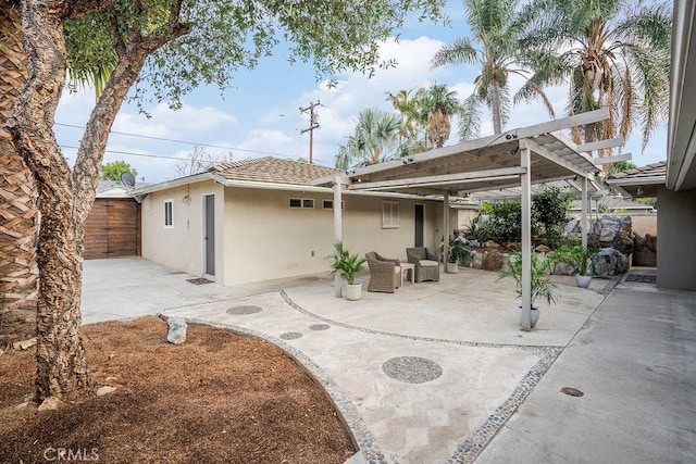 rear view of house with a pergola, outdoor lounge area, and a patio