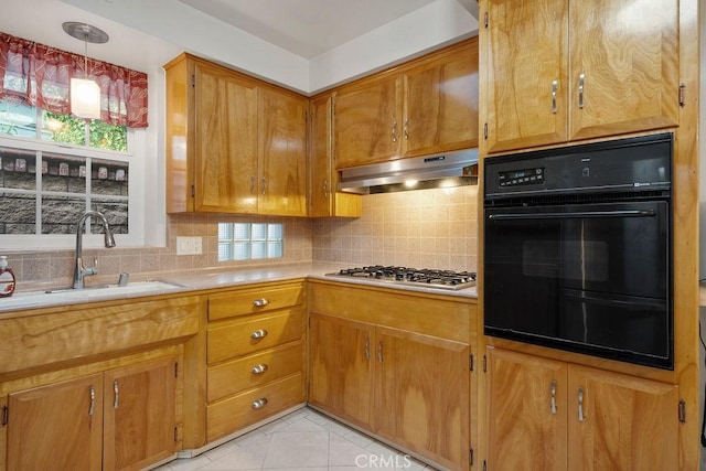 kitchen featuring sink, oven, decorative backsplash, stainless steel gas cooktop, and exhaust hood