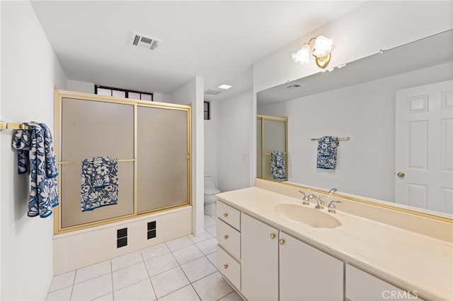 bathroom with tile patterned flooring, vanity, and toilet