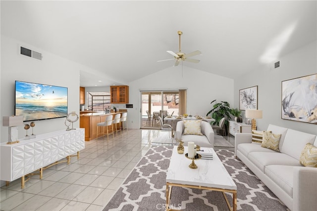 living room featuring high vaulted ceiling, light tile patterned floors, visible vents, and a ceiling fan