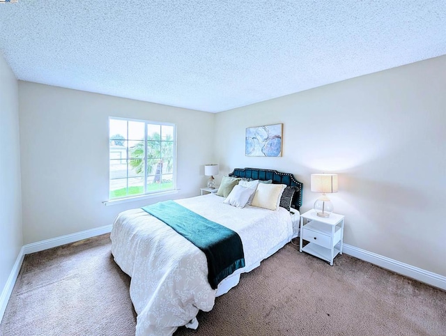 bedroom featuring carpet flooring and a textured ceiling