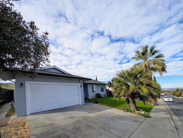 ranch-style home with a garage and a front yard