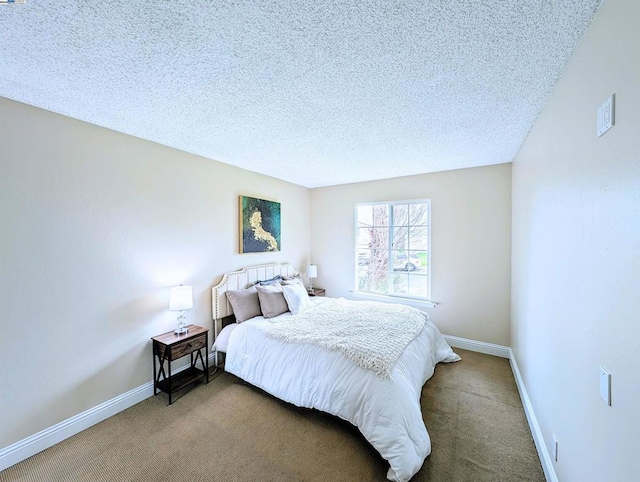 bedroom with a textured ceiling and carpet flooring