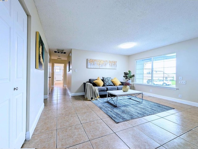 tiled living room featuring plenty of natural light and a textured ceiling