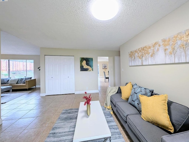 tiled living room featuring a textured ceiling