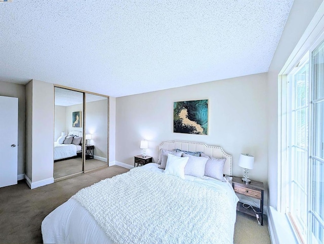 carpeted bedroom with a textured ceiling and a closet