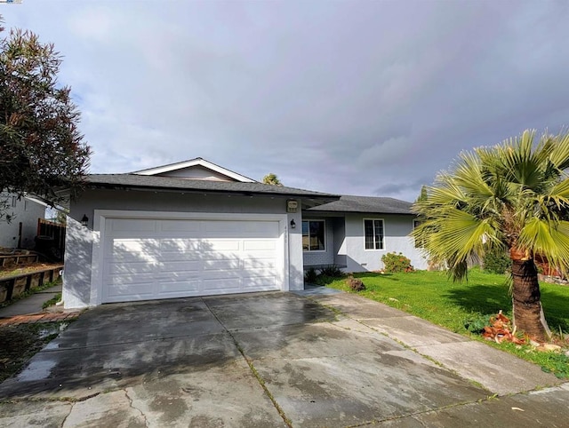 single story home with a garage and a front yard