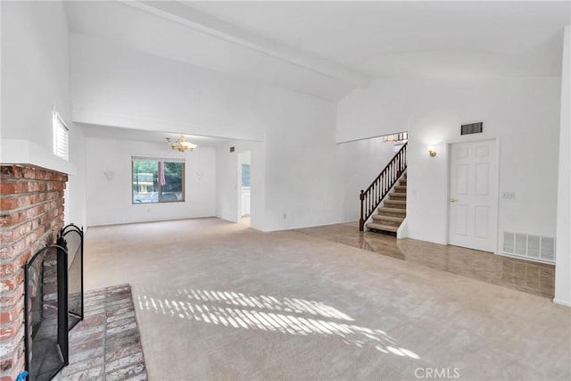 unfurnished living room with light carpet, a fireplace, high vaulted ceiling, and beamed ceiling