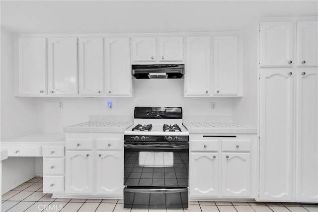 kitchen featuring white cabinetry, gas range, ventilation hood, and light tile patterned flooring