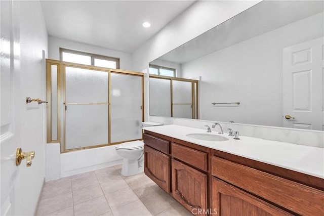 full bathroom with vanity, toilet, tile patterned flooring, and combined bath / shower with glass door