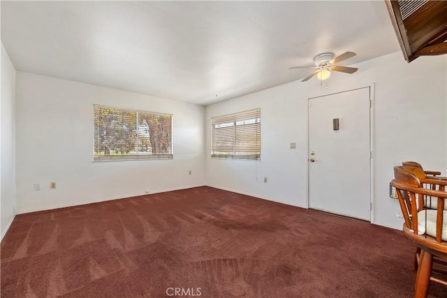 interior space featuring ceiling fan and carpet