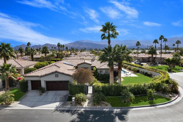 exterior space with a garage and a mountain view