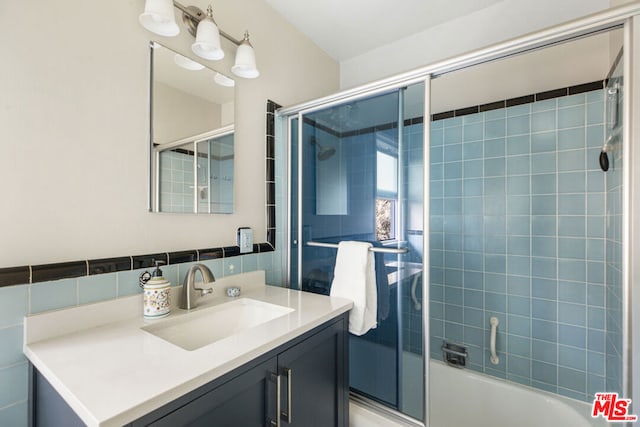 bathroom featuring vanity and combined bath / shower with glass door