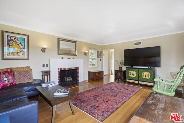 living room featuring hardwood / wood-style flooring and a fireplace