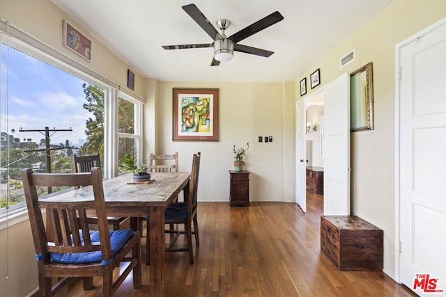 dining room with dark wood-type flooring and ceiling fan