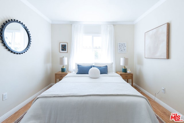 bedroom with hardwood / wood-style flooring and ornamental molding