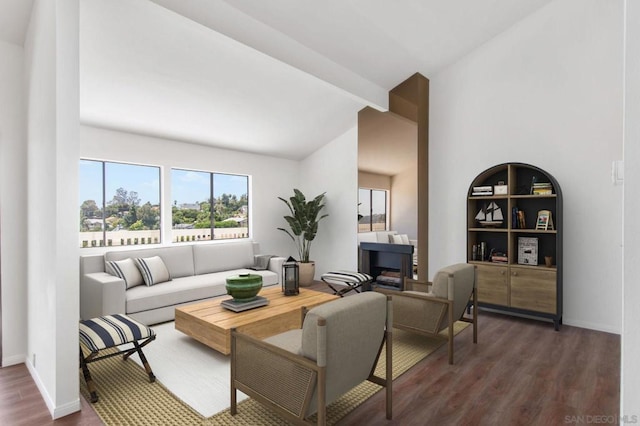 living room with dark wood-type flooring and lofted ceiling with beams