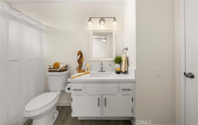 bathroom with vanity, hardwood / wood-style floors, and toilet