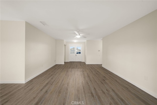 spare room with dark hardwood / wood-style floors and ceiling fan