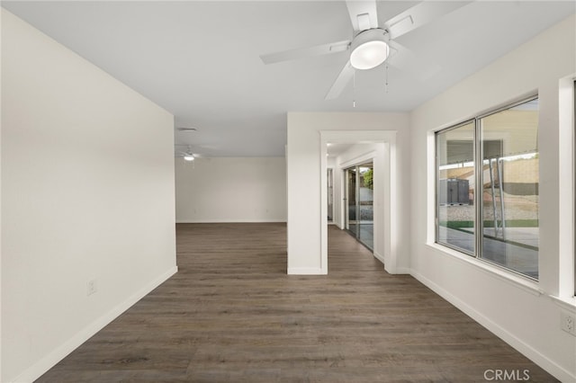 spare room with dark wood-type flooring and ceiling fan