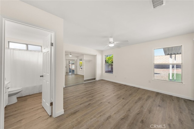 spare room featuring light hardwood / wood-style floors and ceiling fan