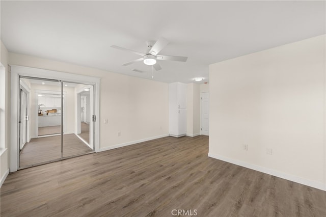 spare room with wood-type flooring and ceiling fan