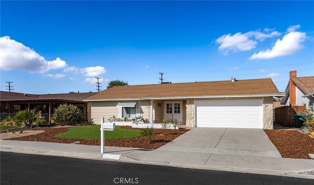 single story home with a garage and a front lawn