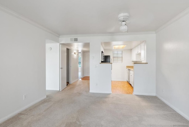 unfurnished living room with ornamental molding and light colored carpet