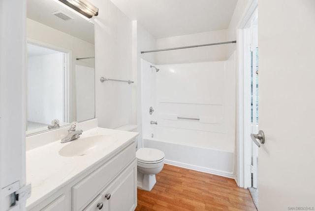 full bathroom featuring vanity, wood-type flooring, shower / bathtub combination, and toilet