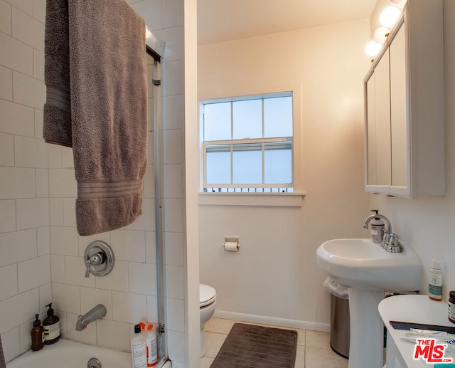 full bathroom featuring tiled shower / bath combo, sink, tile patterned flooring, and toilet