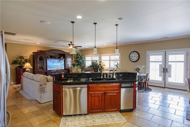 kitchen with a healthy amount of sunlight, stainless steel appliances, sink, and a kitchen island