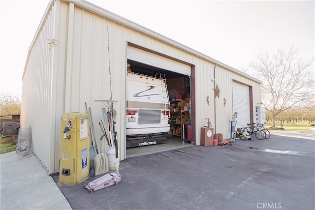 view of outbuilding featuring central AC and a garage