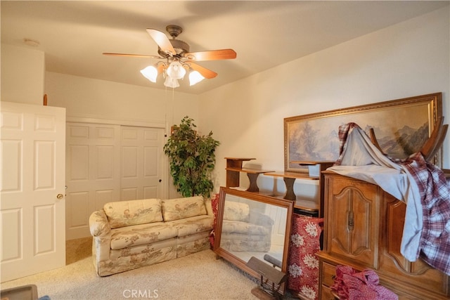 living area featuring ceiling fan and light colored carpet