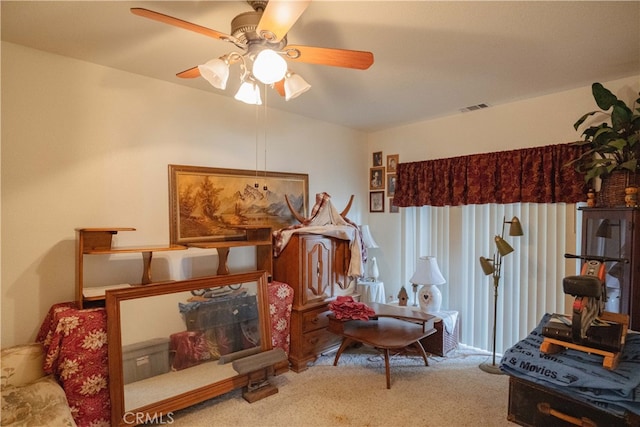 interior space featuring light colored carpet and ceiling fan