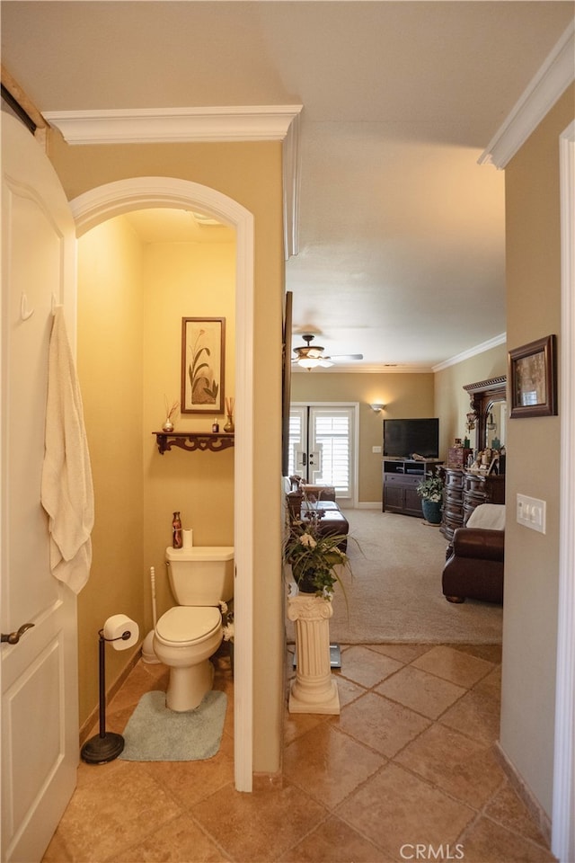 bathroom featuring crown molding, ceiling fan, and toilet