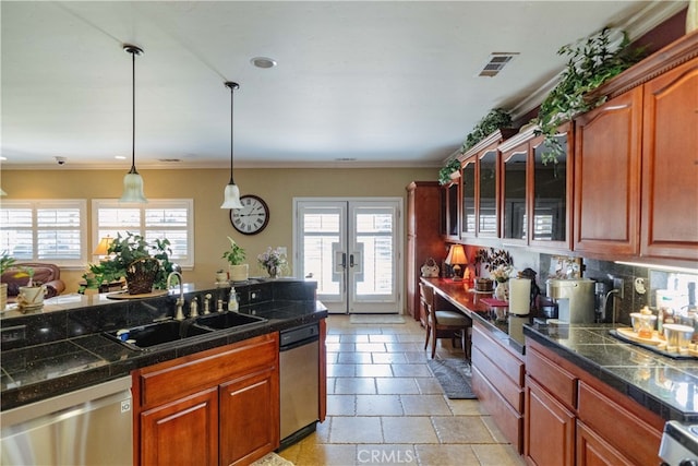 kitchen with pendant lighting, sink, backsplash, stainless steel dishwasher, and french doors