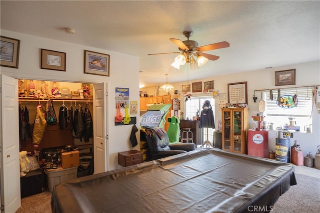 playroom featuring ceiling fan, billiards, carpet, and a textured ceiling