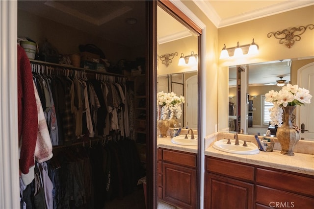 bathroom featuring ornamental molding, vanity, and ceiling fan