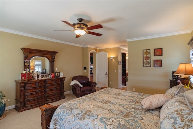 carpeted bedroom featuring crown molding and ceiling fan