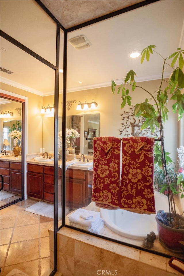 bathroom featuring ornamental molding, vanity, and tiled tub