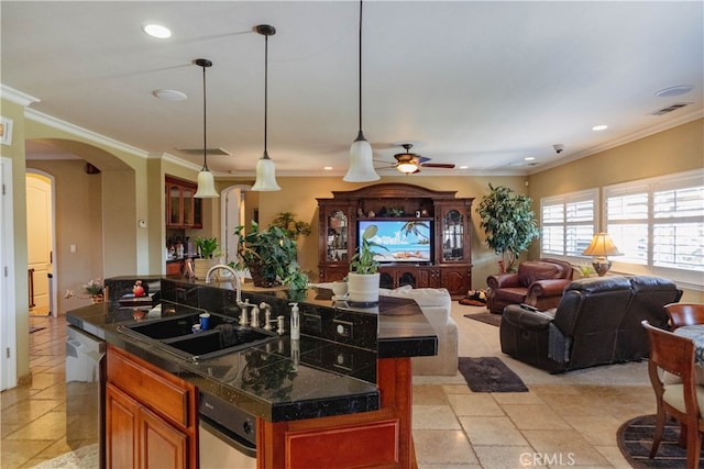 kitchen featuring sink, ornamental molding, an island with sink, and dishwasher