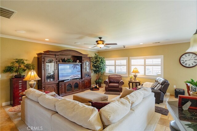 living room with ceiling fan and ornamental molding