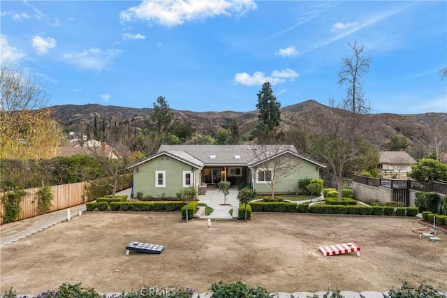 ranch-style home with a patio and a mountain view