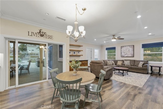 dining area with ornamental molding, plenty of natural light, and dark hardwood / wood-style flooring