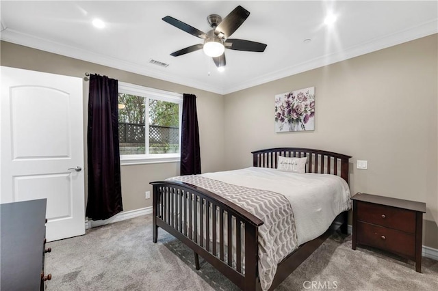 carpeted bedroom with crown molding and ceiling fan