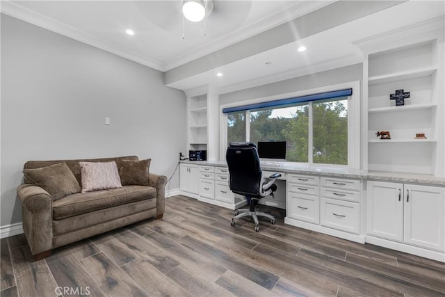 office area featuring built in desk, built in features, ornamental molding, and dark hardwood / wood-style floors