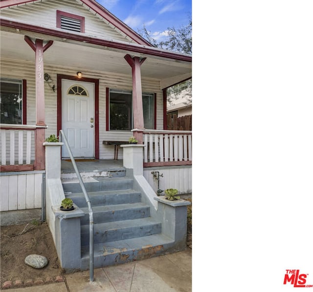 view of exterior entry featuring a porch